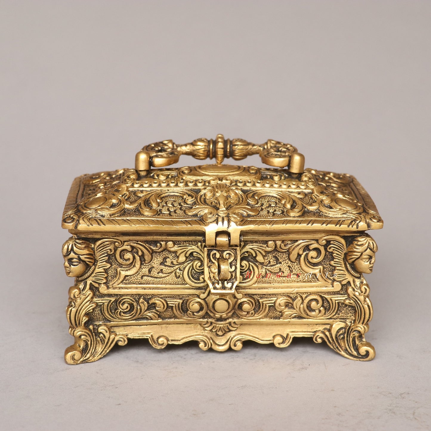 Decorative gold box with intricate designs on a gray background