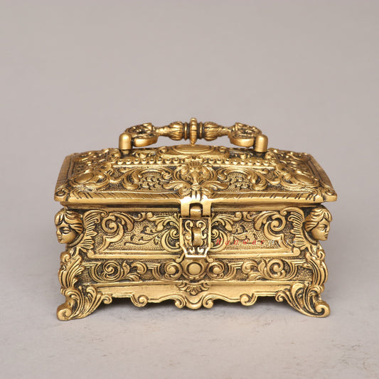 Decorative gold box with intricate designs on a gray background